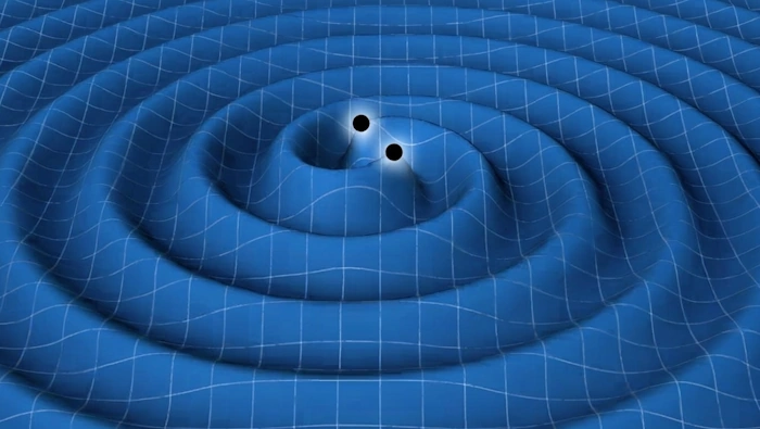 Two black holes spiraling toward each other, warping the blue spacetime grid into deep funnels and concentric ripples, illustrating gravitational distortion.